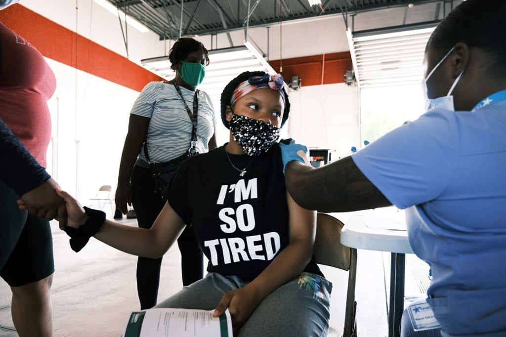 Camora Taylor, 12, receives a coronavirus vaccine in Ferguson, Missouri, US. Photo: Getty Images / TNS