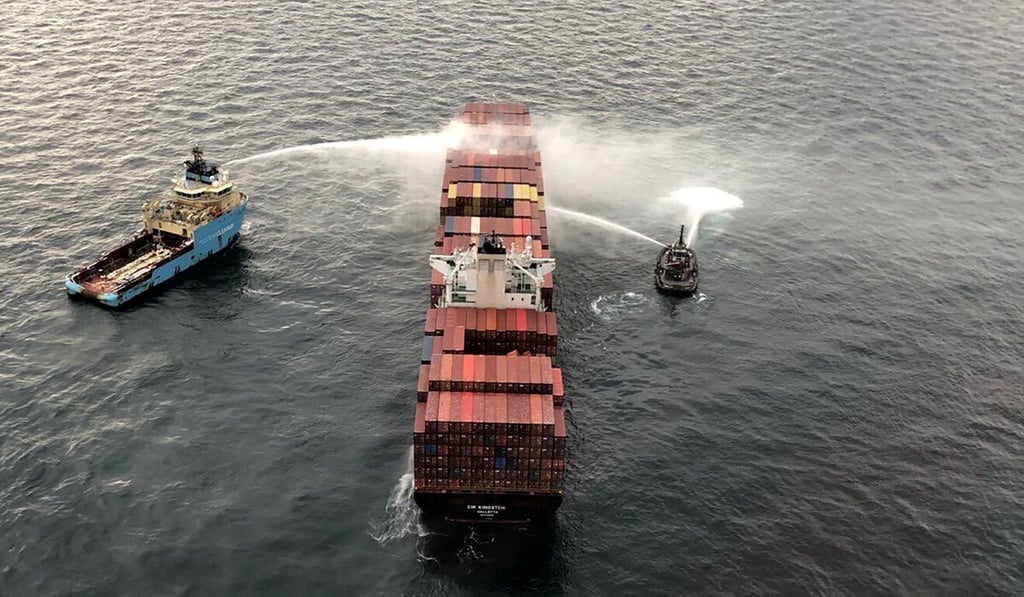 Tug boats sprayed water around the area of the fire to keep it from spreading. Photo: Reuters
