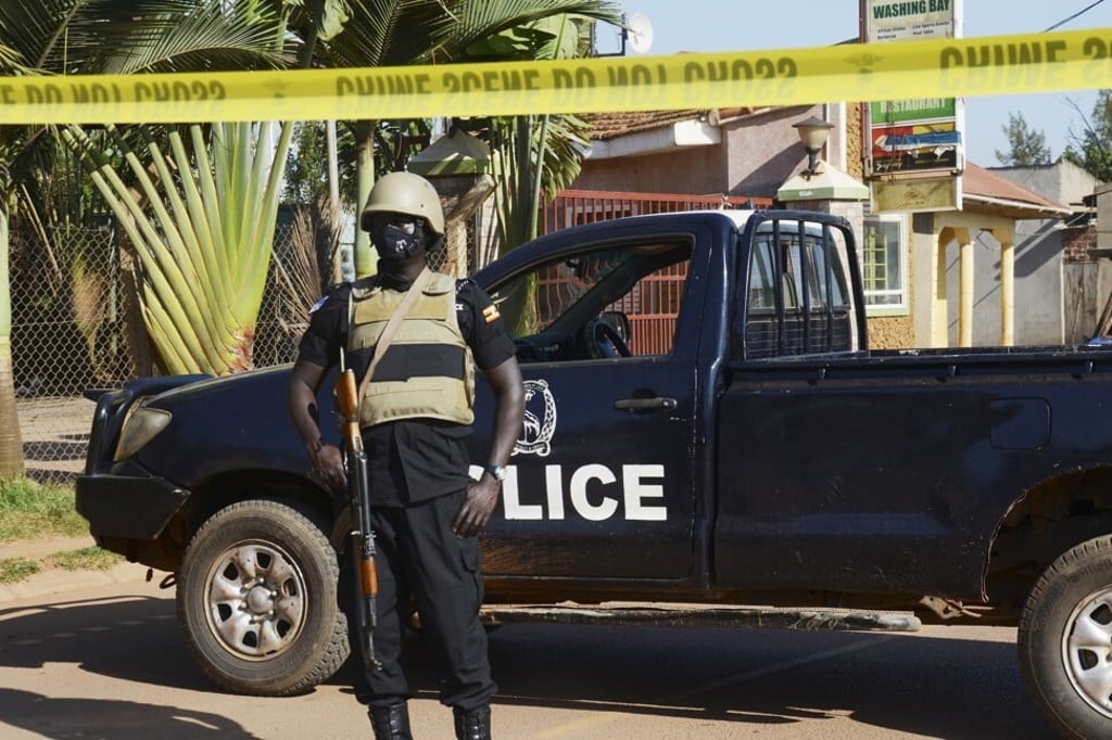 A Ugandan policeman secures a road near the scene of a bomb explosion at a bar near Digida Pork Joint in Kampala, Uganda on Sunday. Photo: EPA-EFE