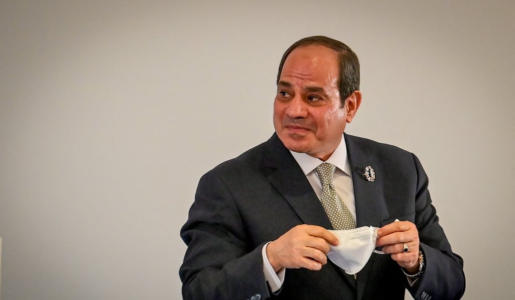 Egypt's President Abdel Fattah el-Sisi replaces his face mask after a trilateral meeting between Greece, Egypt and Cyprus in Athens on October 19. Photo: AFP