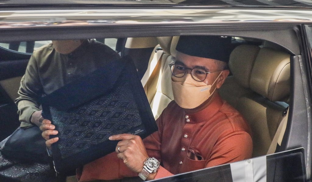 Malaysian Finance Minister Tengku Zafrul Abdul Aziz holds a briefcase containing the 2022 Budget as he heads to Parliament House in Putrajaya. Photo: EPA