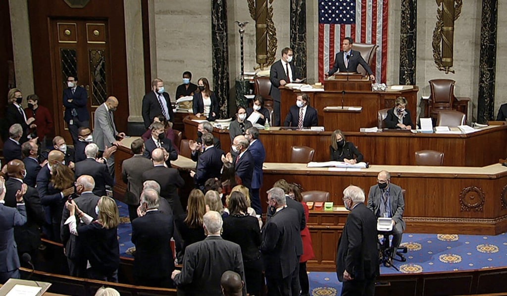 Democrats celebrate on the House floor late on Friday after the approval of the US$1 trillion package. Photo: House Television via AP