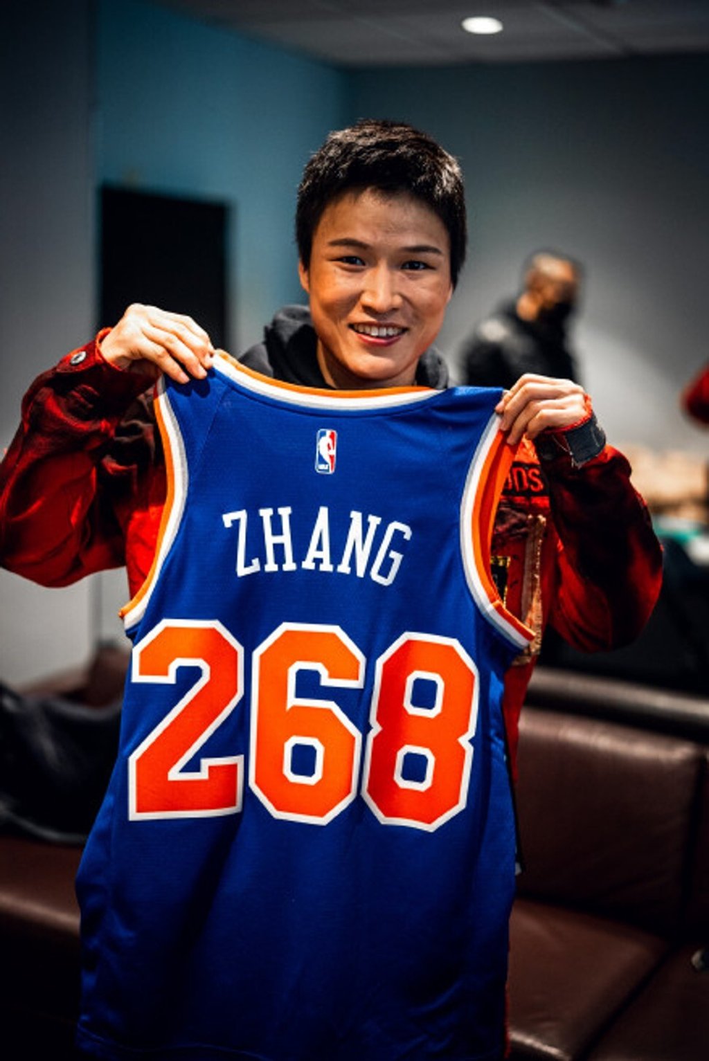 Chinese UFC star Zhang Weili holds a New York Knicks jersey bearing her name and the No 268 ahead of UFC 268 at Madison Square Garden in New York. Photo: Weibo