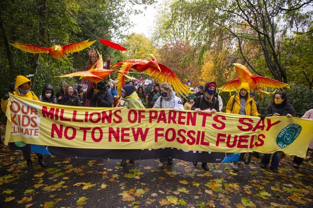 Parents and children from around the world call on leaders to end financing for fossil fuels, in Glasgow, Scotland on Saturday. Photo: AP Images for AVAAZ