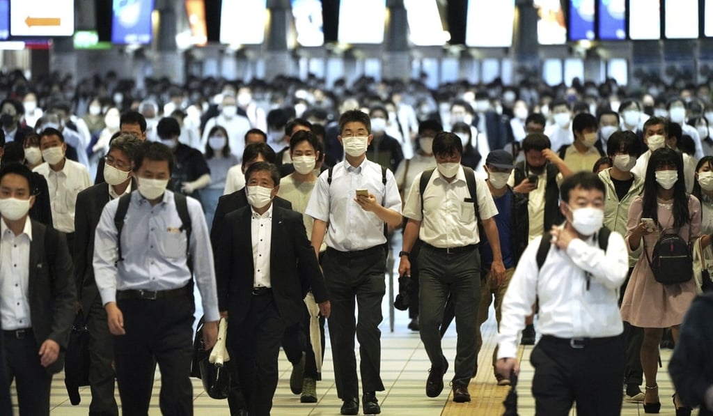 Commuters pictured in Tokyo last month. Japan’s daily Covid-19 caseload has fallen sharply since September. Photo: AP
