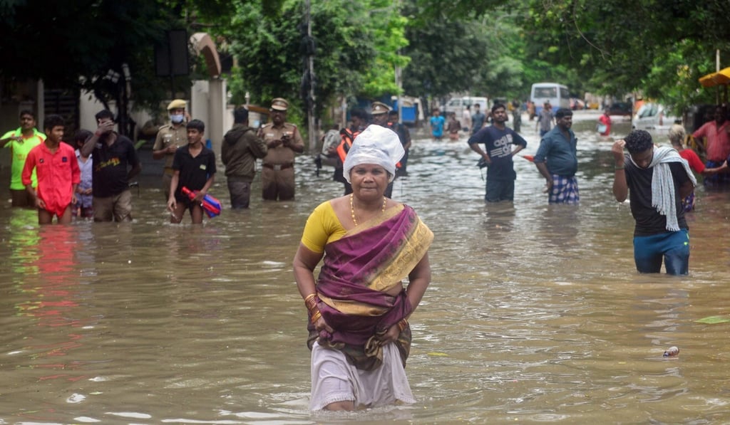 People wade through a flooded street in Chennai on November 7. Photo: AFP People wade through a flooded street in Chennai on November 7. Photo: AFP