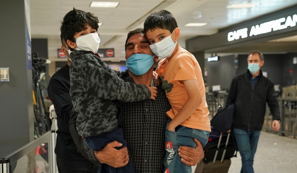 Abdul Shukoor lifts up his nephews when reunited with them in Virginia upon his arrival from Brussels, as the US reopens air and land borders to vaccinated travellers. Photo: Reuters