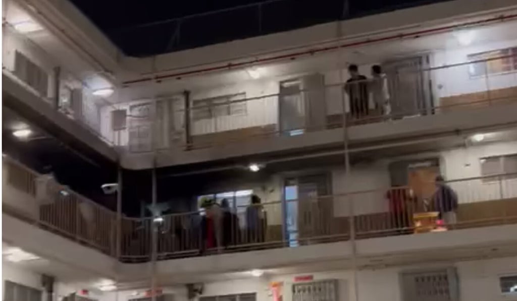 Residents mill outside their flats in Tuen Mun’s Wu Pik House on Monday night after two petrol bombs exploded in the corridor. Photo: Facebook