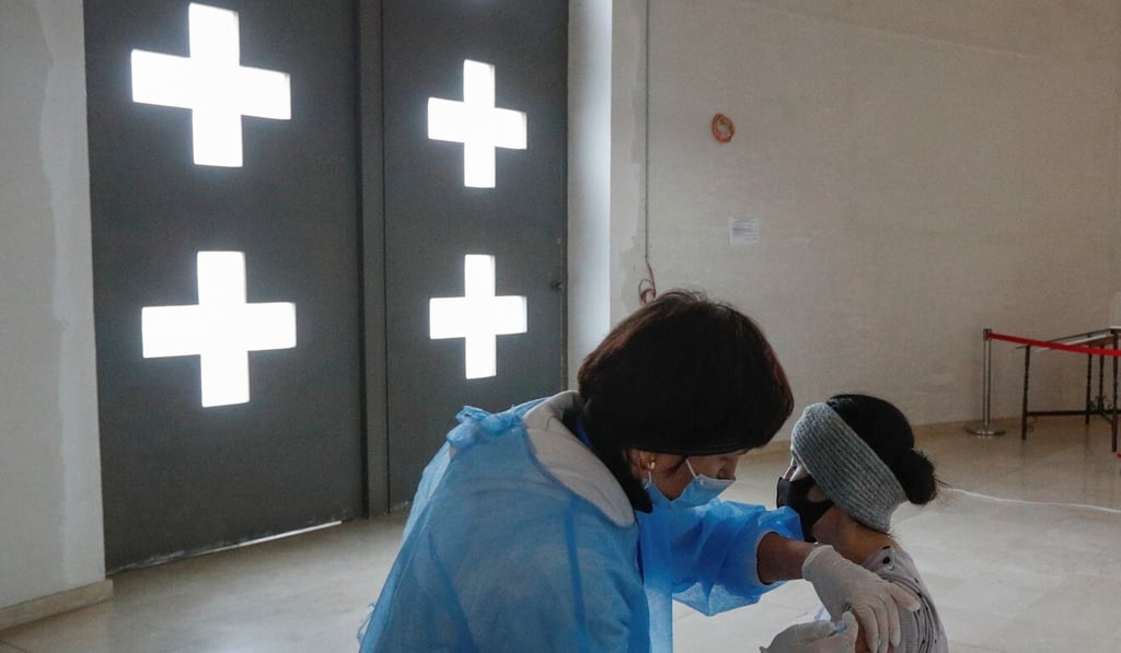 A woman receives a vaccine against Covid-19 at the vaccination centre in a Kyiv cathedral on Monday. Photo: Reuters