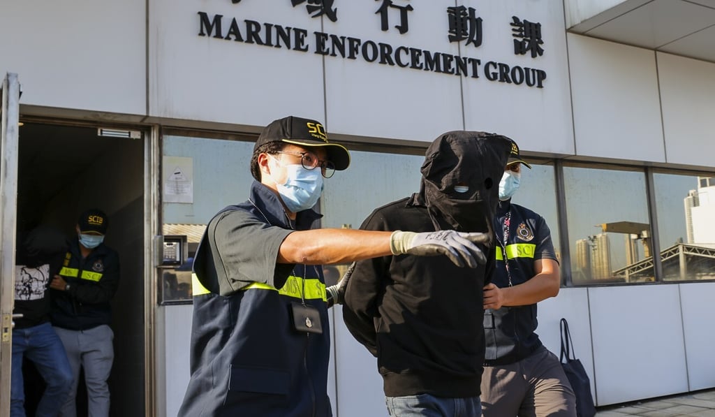 Customs officers have arrested two mainland men after finding 77 boxes of contraband on the speedboat. Photo: Dickson Lee Customs officers have arrested two mainland men after finding 77 boxes of contraband on the speedboat. Photo: Dickson Lee