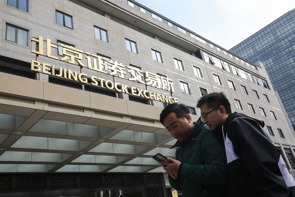 Investors looking at their smartphone outside the new Beijing Stock Exchange on Monday November 15, 2021. Photo: Simon Song