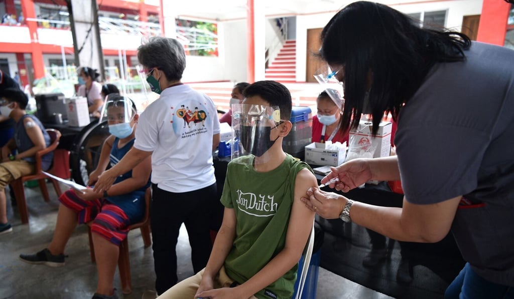 Teenagers receive doses of Covid-19 vaccine during an inoculation drive for young people earlier this month at a school in Taguig City, Metro Manila. Photo: AFP