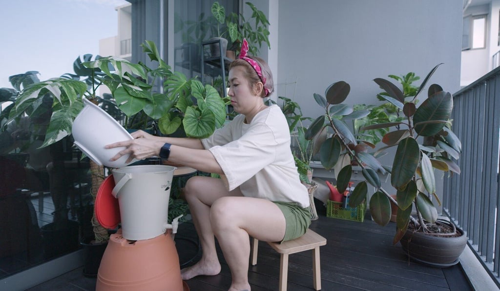 Geraldine Guo adds waste materials which she collects during the couple's ‘kueh’ production to her home composting system as part of efforts to provide a whole circular economy. Geraldine Guo adds waste materials which she collects during the couple's ‘kueh’ production to her home composting system as part of efforts to provide a whole circular economy.