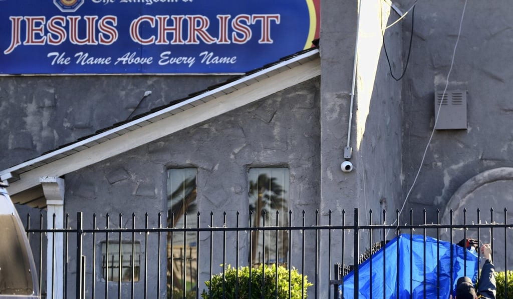 FBI agents cover a fence on the grounds of the Kingdom of Jesus Christ Church in Los Angeles last year. Photo: AP FBI agents cover a fence on the grounds of the Kingdom of Jesus Christ Church in Los Angeles last year. Photo: AP