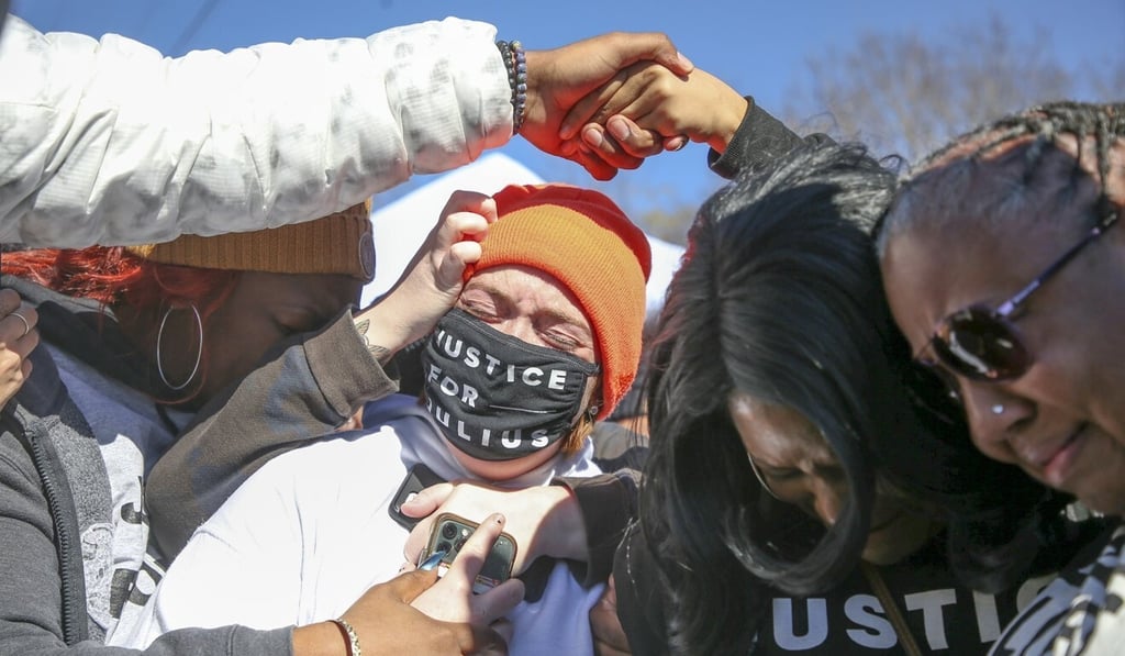 A protester celebrates with supporters while Dr Tiffany Crutcher and Reverend T. Sheri Dickerson hug outside the Oklahoma State Penitentiary after hearing that Julius Jones was granted a stay of execution on Thursday. Photo: Tulsa World via AP)