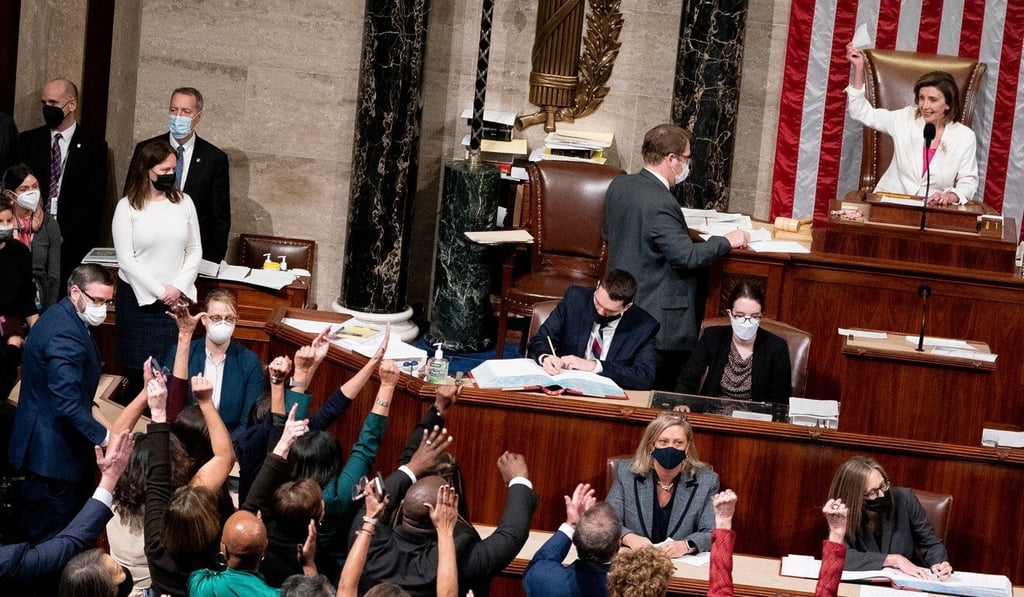 House Democrats celebrate as US House Speaker Nancy Pelosi (right) holds up the vote tally following a vote at the US Capitol on Friday. Photo: Bloomberg House Democrats celebrate as US House Speaker Nancy Pelosi (right) holds up the vote tally following a vote at the US Capitol on Friday. Photo: Bloomberg