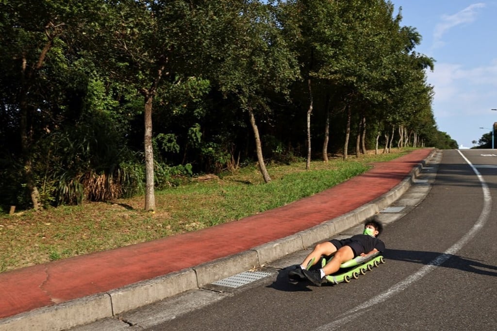 Li Sin-rong slides down a road, on wheels rather than blades, during training for Beijing. Photo: Reuters