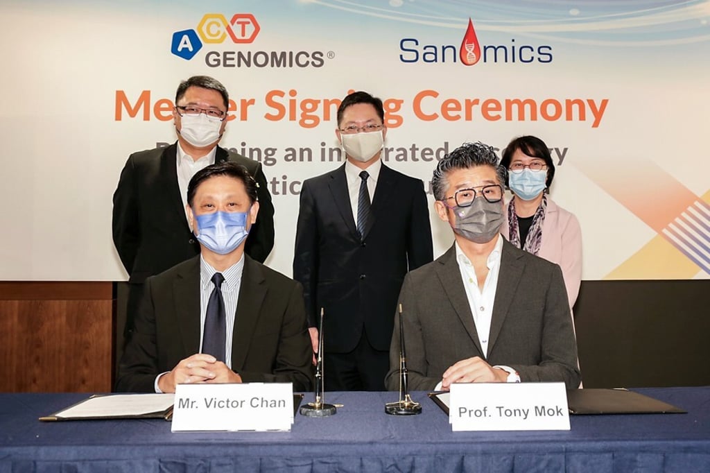 ACT Genomics chief financial officer Victor Chan (seated left) and chairman Tony Mok (seated right) at the merger signing ceremony of ACT Genomics with Sanomics Holdings on Monday. Photo: Handout ACT Genomics chief financial officer Victor Chan (seated left) and chairman Tony Mok (seated right) at the merger signing ceremony of ACT Genomics with Sanomics Holdings on Monday. Photo: Handout