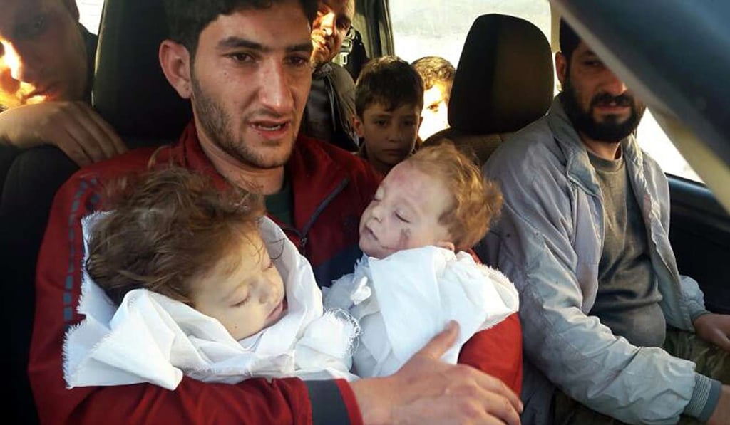 Abdel Hameed Alyousef, 29, holds his twin babies who were killed during a suspected chemical weapons attack, in Khan Sheikhun. Photo: AP