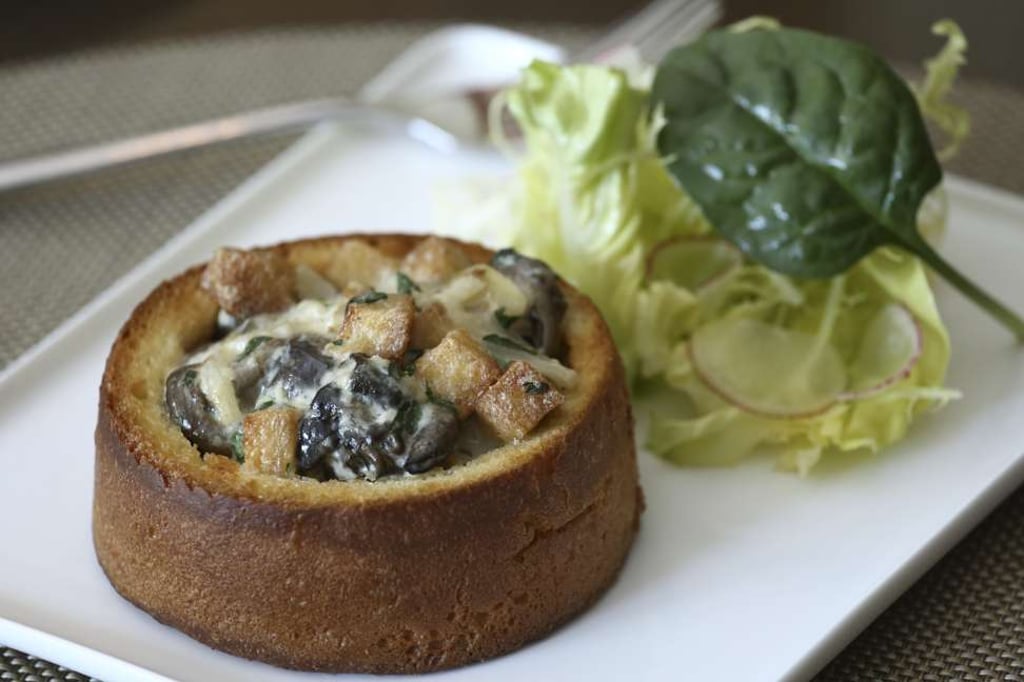 Sautéed escargots with garlic, onion and bacon on toasted brioche. Photo: Jonathan Wong