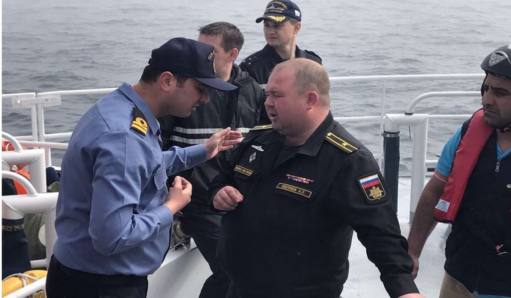 A Turkish coast guard officer helps Russian sailors after their reconnaissance vessel Liman collided with another ship and sank the Bosphorus Strait. Photo: EPA A Turkish coast guard officer helps Russian sailors after their reconnaissance vessel Liman collided with another ship and sank the Bosphorus Strait. Photo: EPA
