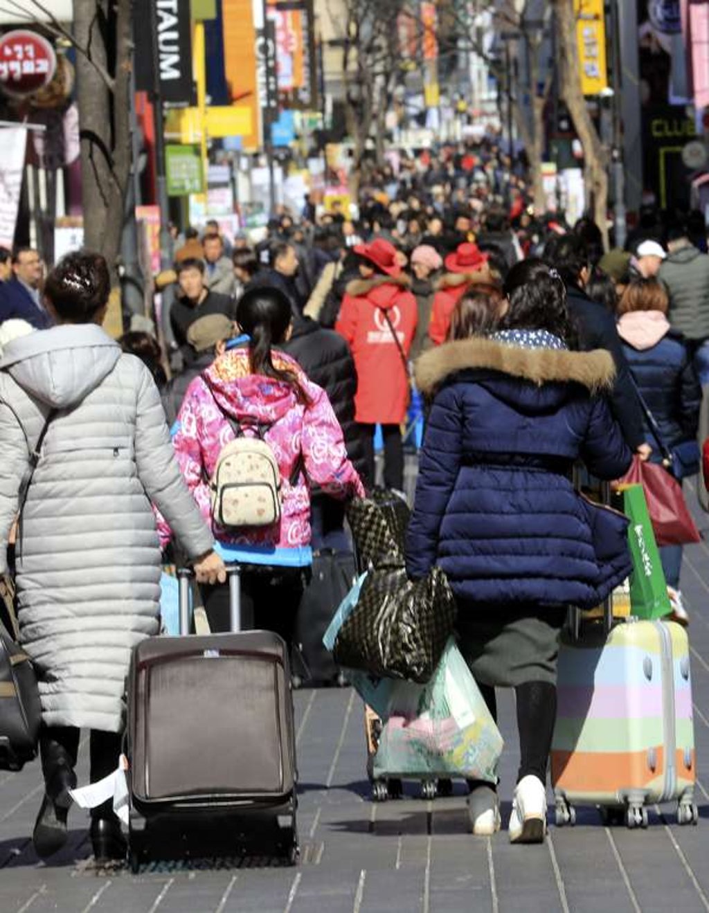 Chinese tourists walk down Seoul's Myeongdong street in South Korea, amid concerns that China's move to order the country's travel agencies last week to suspend their tour programmes to South Korea will hurt the South Korean tourism industry. Photo: EPA