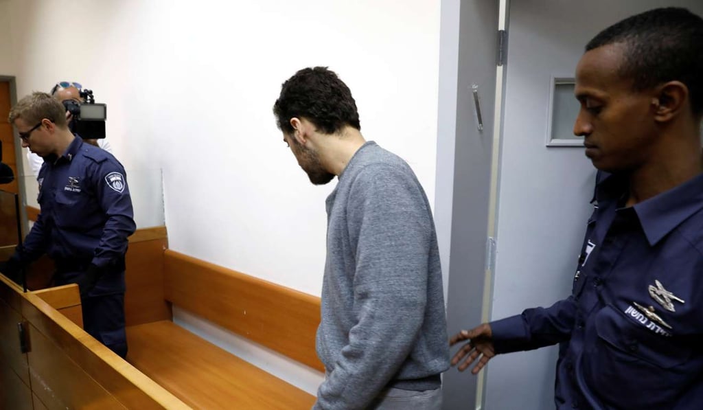An US-Israeli teen, who was arrested in Israel on suspicion of making bomb threats against Jewish community centres in the United States, Australia and New Zealand, arrives before the start of a remand hearing. Photo: Reuters