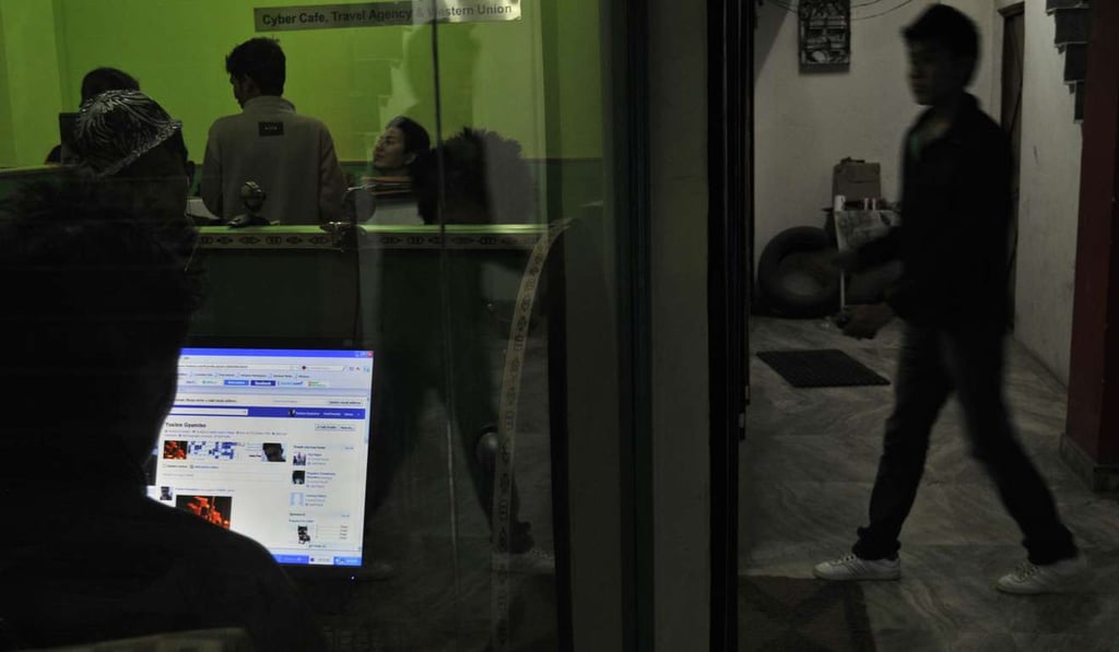 A man logs into Facebook at an internet café in New Delhi. Photo: AFP