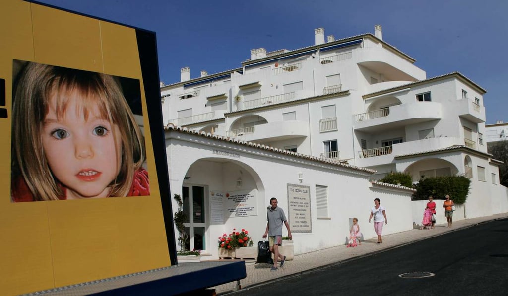 People walk near a billboard of Madeleine McCann at Praia da Luz tourist resort in Portugal. File photo: Reuters