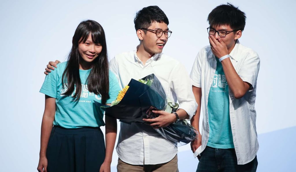 Nathan Law (centre) celebrates with fellow Demosisto members Agnes Chow and Joshua Wong after winning a seat in Hong Kong Island constituency. Photo: Dickson Lee