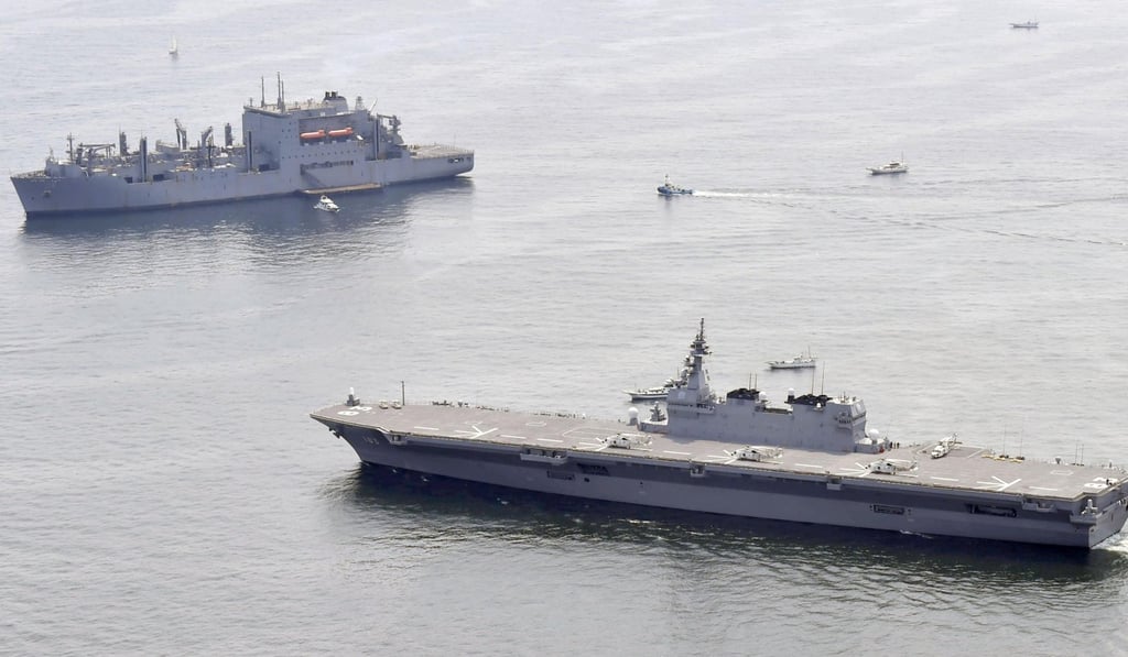 Japanese helicopter carrier Izumo sails by a US supply ship (left) at anchor in the waters off Yokosuka, south of Tokyo, on May 1. Photo: AP Japanese helicopter carrier Izumo sails by a US supply ship (left) at anchor in the waters off Yokosuka, south of Tokyo, on May 1. Photo: AP