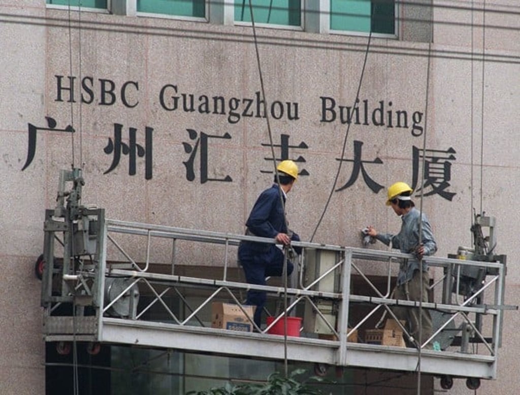 Workers at the HSBC Guangzhou Building in Guangzhou, China.