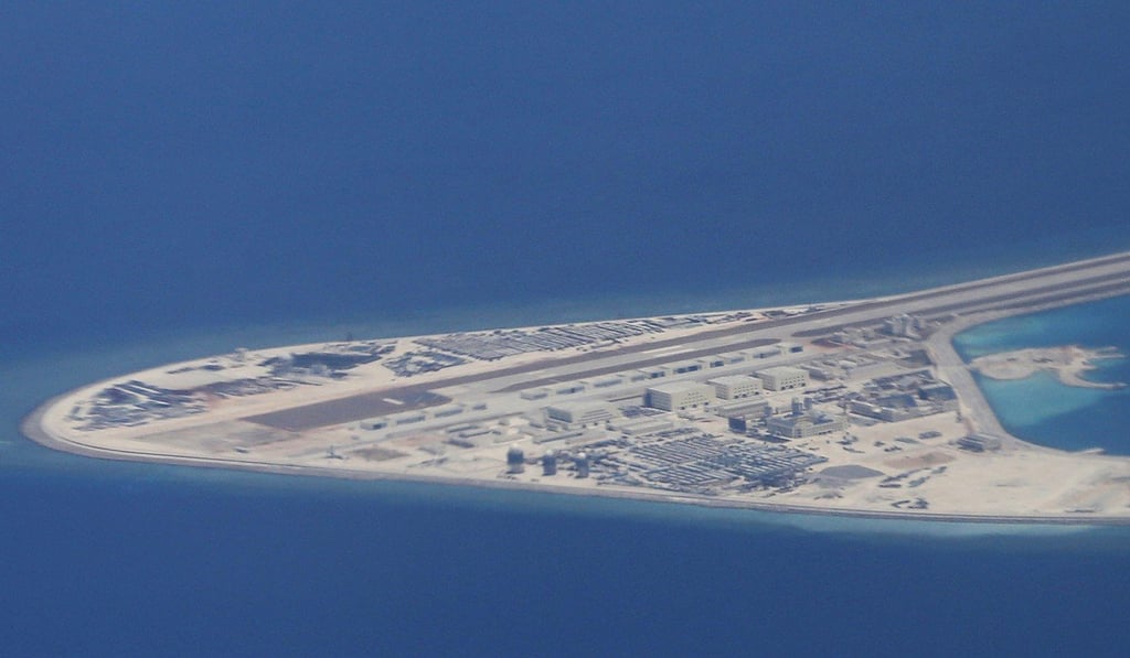 An airstrip, structures and buildings on China's man-made Subi Reef in the Spratly chain of islands in the South China Sea are seen from a Philippine Air Force C-130 transport plane of the Philippine Air Force on April 21. Photo: AP