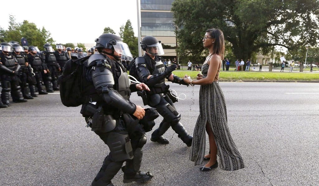 Activist Ieshia Evans stands her ground while offering her hands for arrest by riot police during a protest against the shooting of Alton Sterling, outside the Baton Rouge Police Department in Louisiana last July 9. Photo: Reuters
