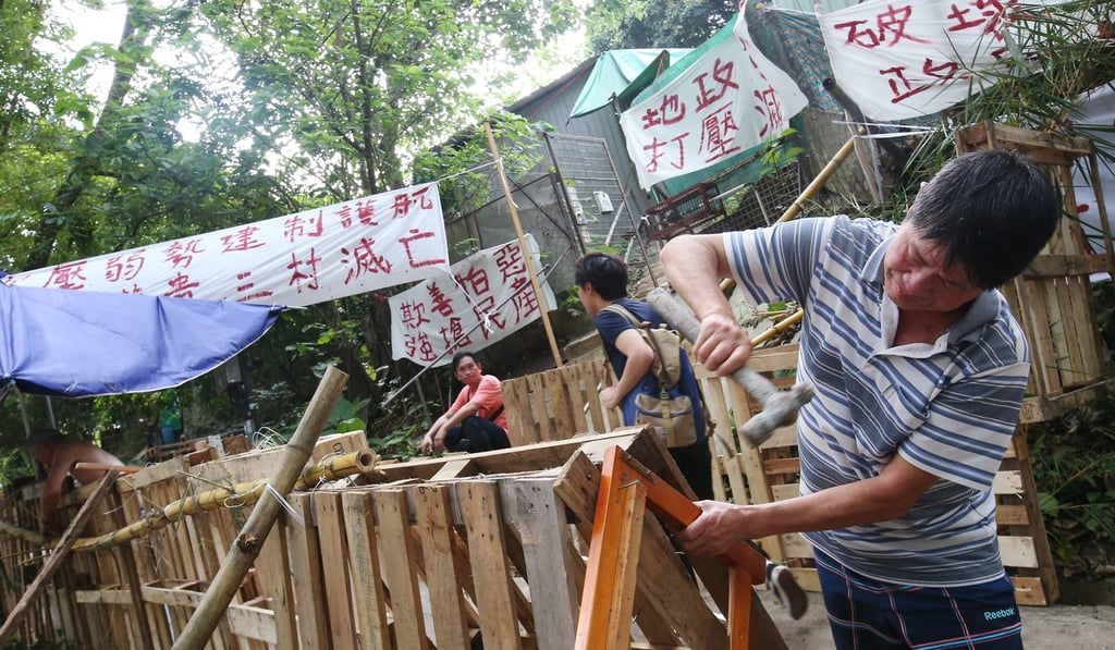 Wang Chau residents put up barricades on the land to prevent officials from entering again. Photo: David Wong