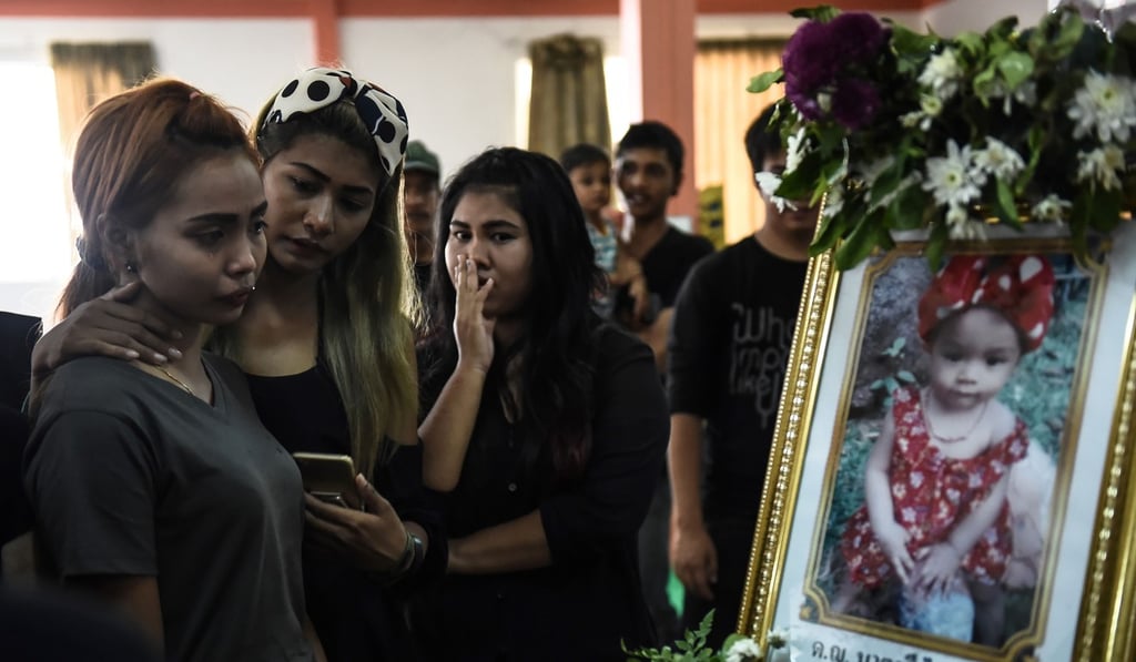Jiranuch Trirat (left is comforted by friends at the funeral of her 11-month-old daughter Natalie in Phuket, Thailand, on April 2. Natalie was murdered by her father in a harrowing video he broadcast live on Facebook before committing suicide. Photo: AFP Jiranuch Trirat (left is comforted by friends at the funeral of her 11-month-old daughter Natalie in Phuket, Thailand, on April 2. Natalie was murdered by her father in a harrowing video he broadcast live on Facebook before committing suicide. Photo: AFP