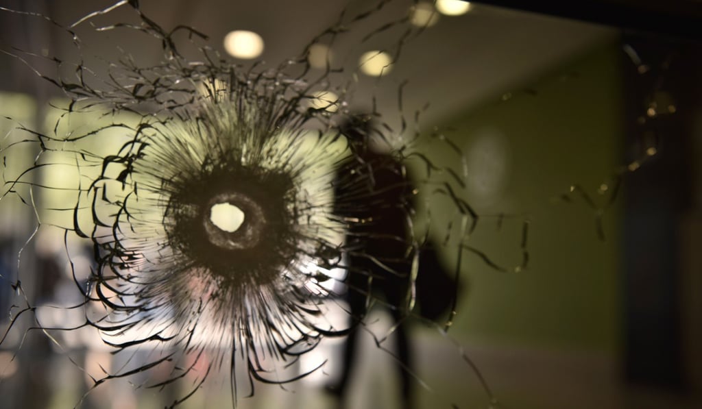 A bullet hole on a window of a building on the Champs Elysees in Paris a day after a gunman opened fire on police, killing an officer and wounding two others in an attack claimed by Islamic State. Photo: AFP
