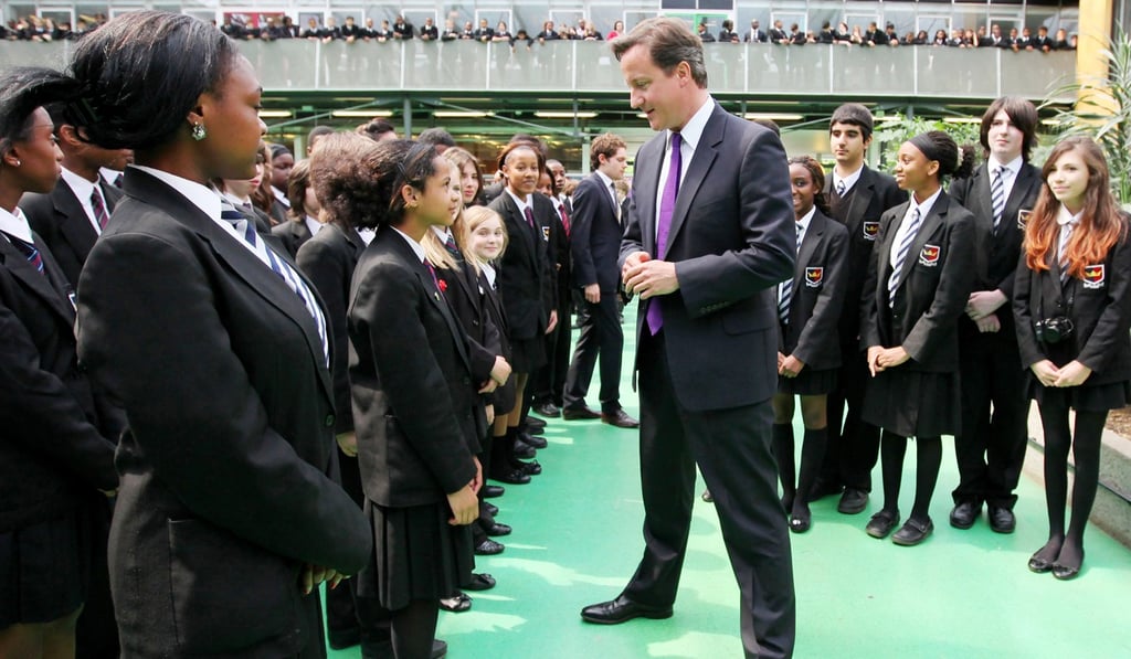 Then British Prime Minister David Cameron (centre) meets students at a school in London, in 2011. Picture: AFP