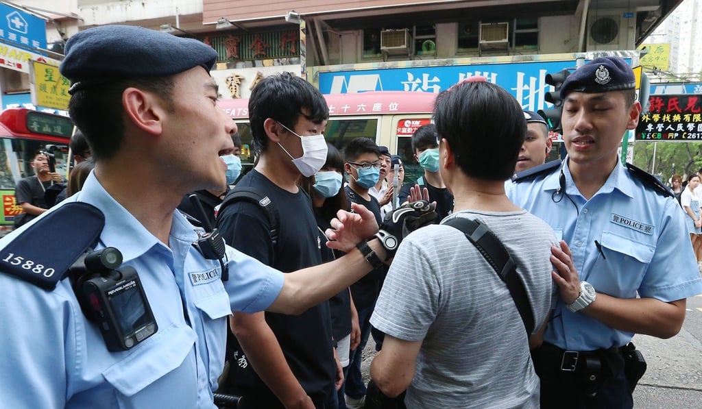 Police officers surround protesters during a protest against parallel traders in Sheung Shui. Photo: K. Y. Cheng