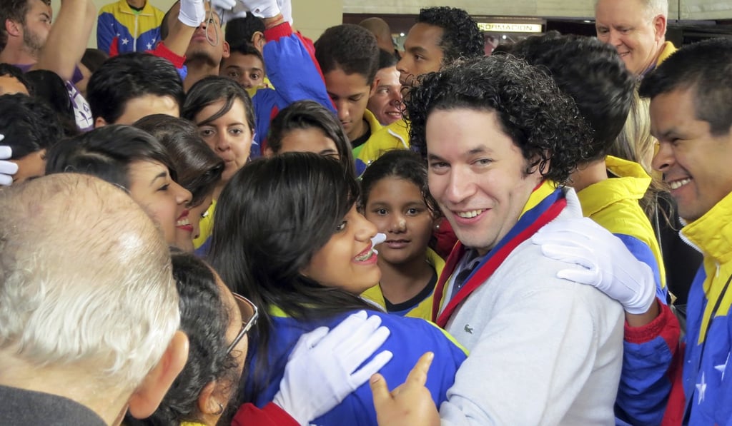 Gustavo Dudamel among students at a showcase performance of El Sistema in 2012. Photo: TNS Gustavo Dudamel among students at a showcase performance of El Sistema in 2012. Photo: TNS