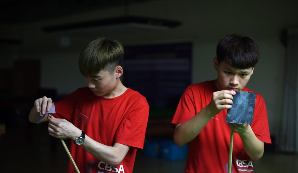 Students preparing their cues at the World Snooker College in Beijing. AFP PHOTO / Greg Baker Students preparing their cues at the World Snooker College in Beijing. AFP PHOTO / Greg Baker
