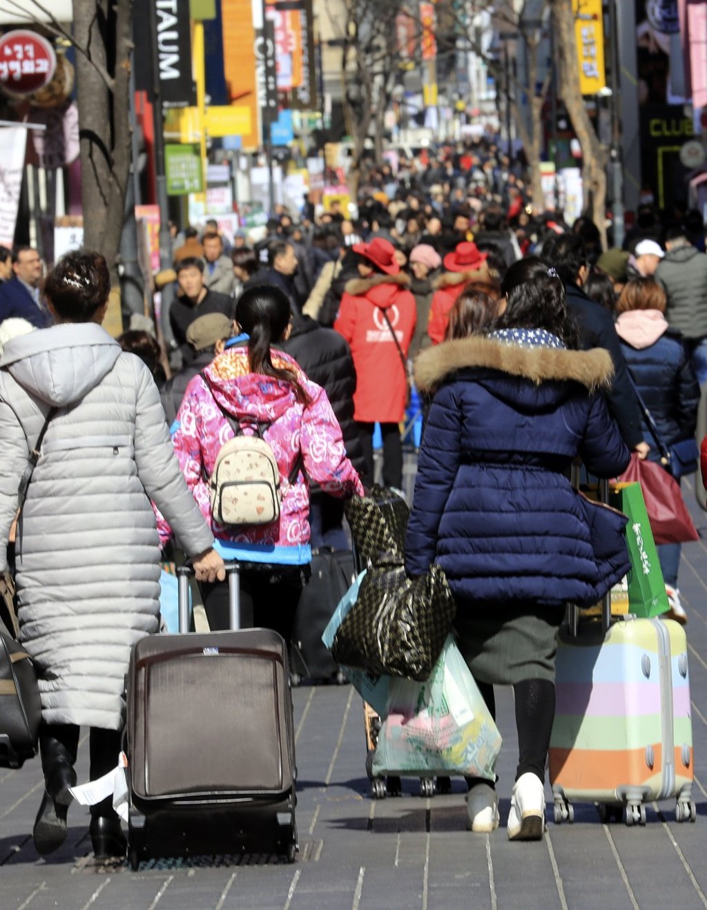 Chinese tourists walk down Seoul’s Myeongdong street, South Korea. China’s ban on tour groups visiting the country has hits the industry hard. Photo: EPA