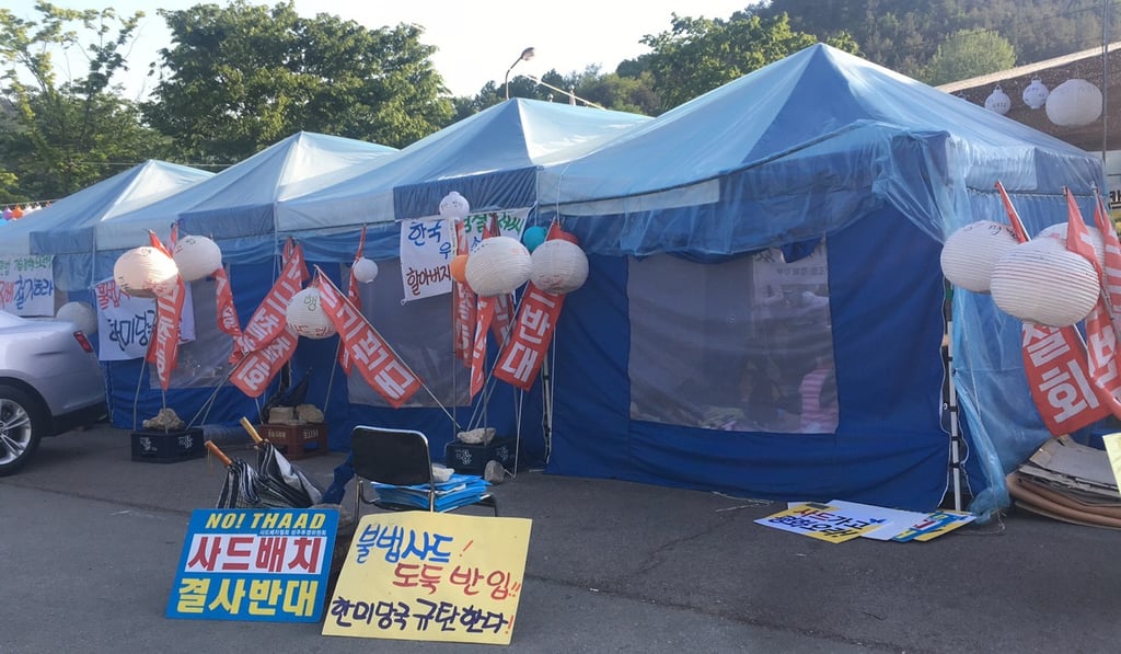 People in South Korea’s Seongju county, where was selected as the location for the deployment of Terminal High Altitude Area Defence (THAAD), stage protest against the missile defence system. Photo: Liu Zhen