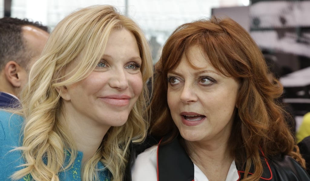 Actress Susan Saradon, right, is flanked by singer Courtney Love prior to the start of the women's Prada Cruise mid season collection, first ever runway show. Photo: AP Actress Susan Saradon, right, is flanked by singer Courtney Love prior to the start of the women's Prada Cruise mid season collection, first ever runway show. Photo: AP