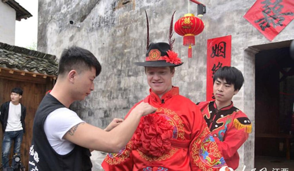 Edward in his ornately embroidered red bridal costume. Photo: Handout