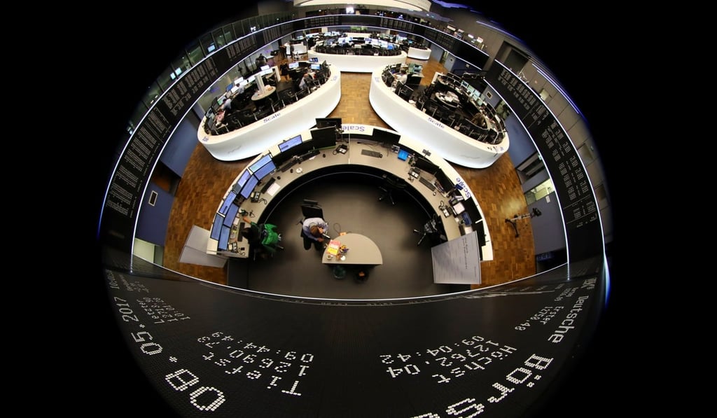 Traders work in front of the German share price index, DAX board, at the stock exchange in Frankfurt, Germany. Photo: Reuters
