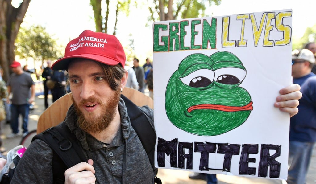 Andrew Knight holds a sign of Pepe the frog, an alt-right conservative icon, during a rally in Berkeley, California on April 27. Photo: AFP Andrew Knight holds a sign of Pepe the frog, an alt-right conservative icon, during a rally in Berkeley, California on April 27. Photo: AFP