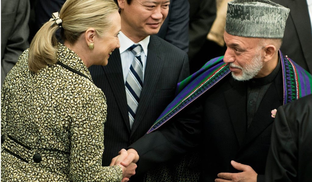 US secretary of state Hillary Clinton shakes hands with Afghan president Hamid Karzai in Tokyo in July 2012. Photo: AFP