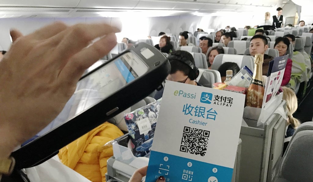 A flight attendant collects payment with Alipay on a flight bound for Helsinki from Beijing. With a smartphone, people can pay for almost everything, such as repairing cars, paying for a taxi or registering at a hospital. Photo: Xinhua A flight attendant collects payment with Alipay on a flight bound for Helsinki from Beijing. With a smartphone, people can pay for almost everything, such as repairing cars, paying for a taxi or registering at a hospital. Photo: Xinhua