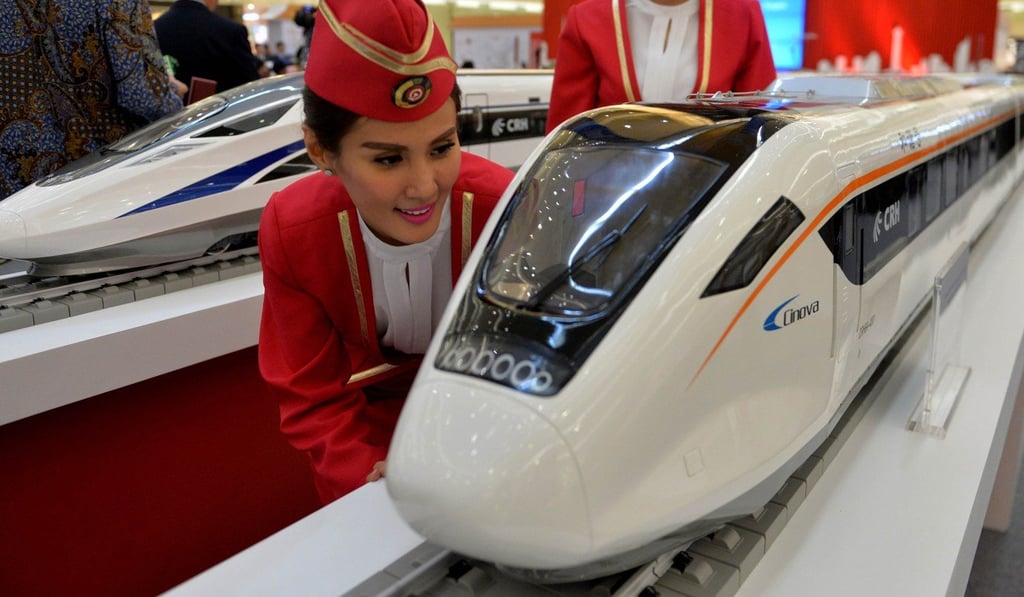 An Indonesian model looks at a scale model of a Chinese bullet train at a shopping mall in Jakarta in August 2015. Photo: AFP